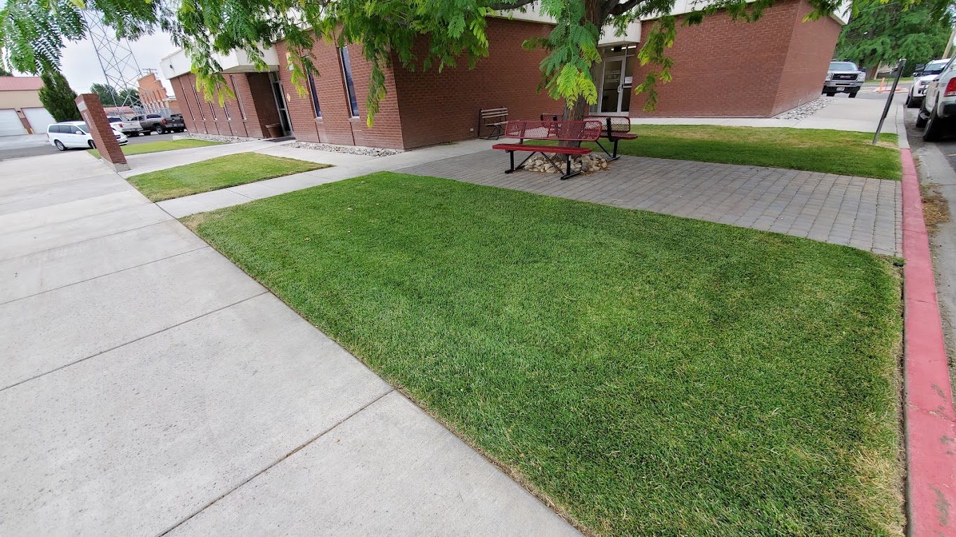 Manicured lawn and paver courtyard at a brick office building