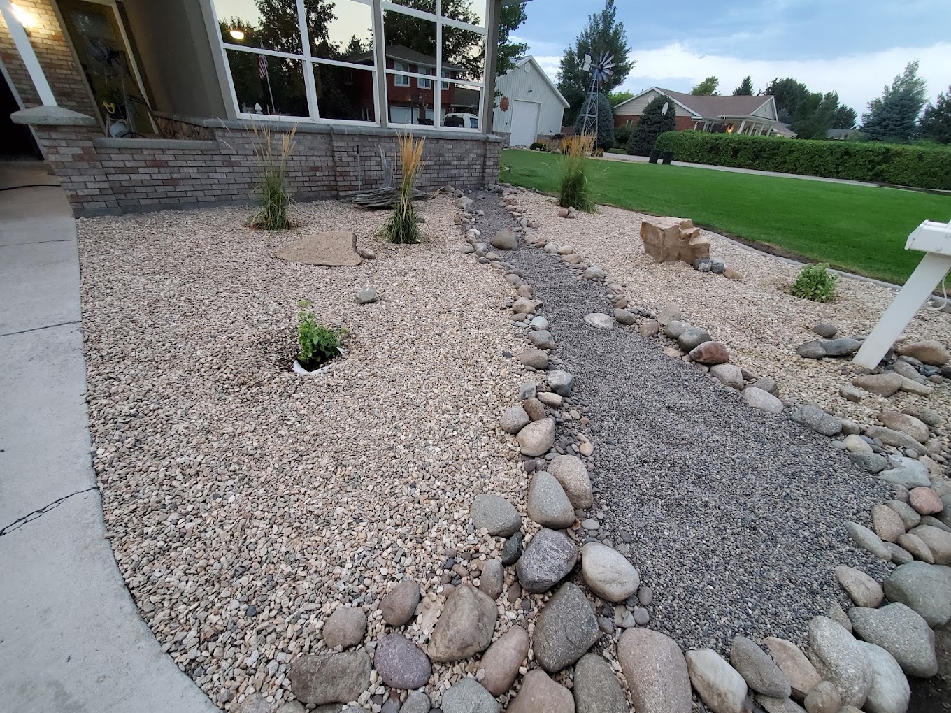 Decorative rock landscaping with dry river bed